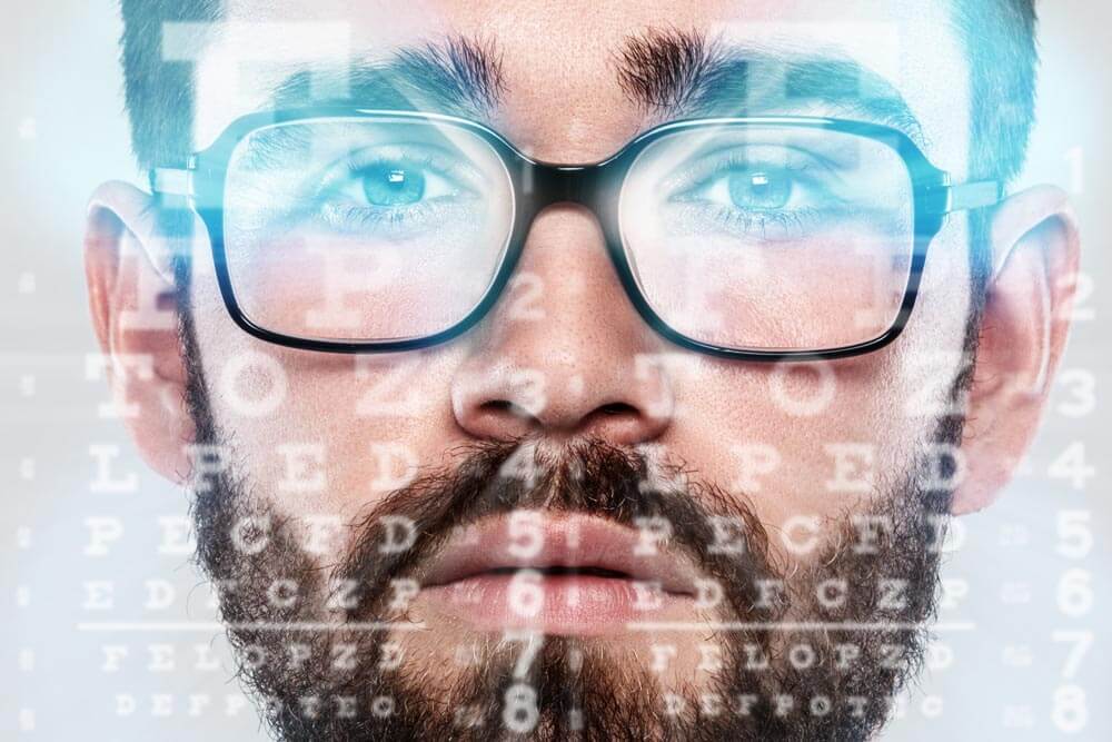 Man wearing glasses and eye chart