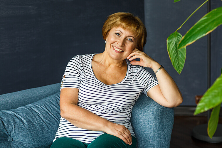 Middle aged woman sitting on couch
